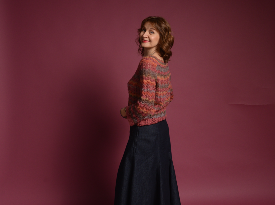 The image shows a heathered red orange knitted sweater in size M